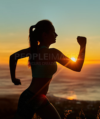 Buy stock photo Cropped shot of a young woman running in the early morning