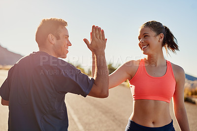 Buy stock photo Cropped shot of two young people high fiving during their workout
