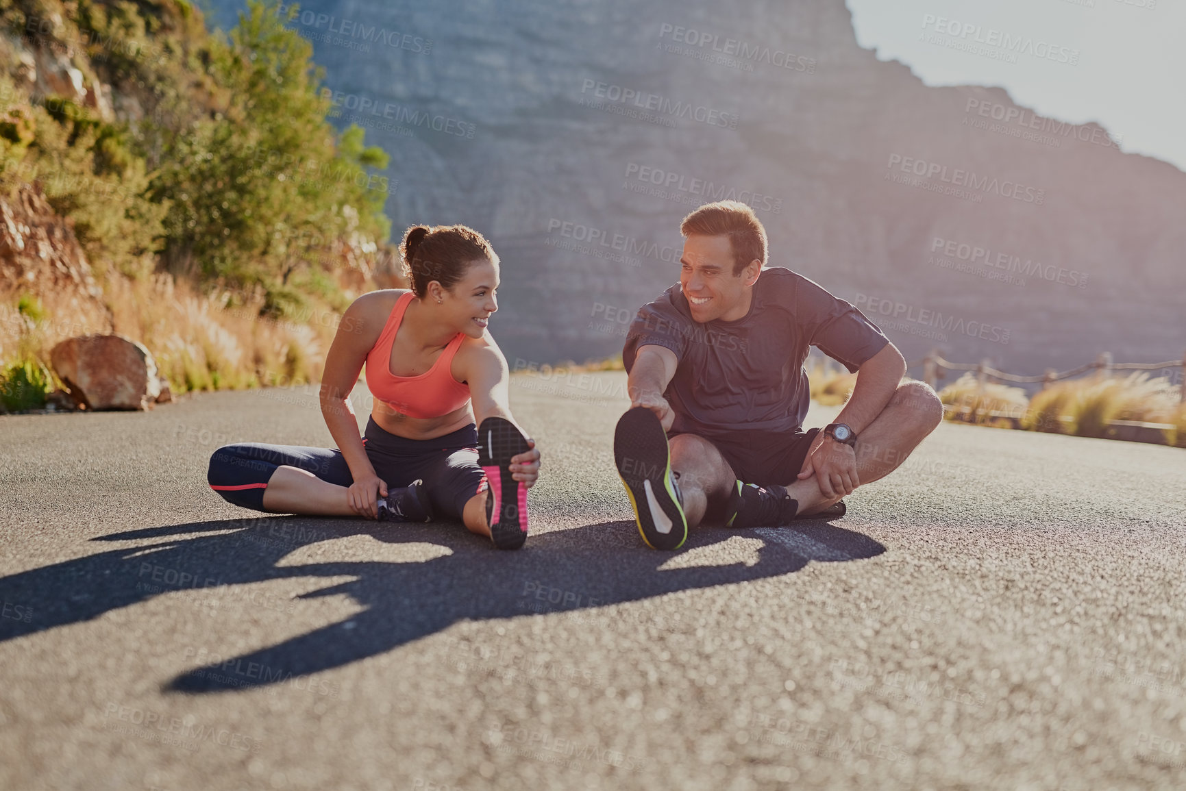 Buy stock photo Stretching, fitness and friends or people smiling for exercise, warm up and marathon training together. Woman, man or sports coach in mountains, trail or wellness workout support or challenge