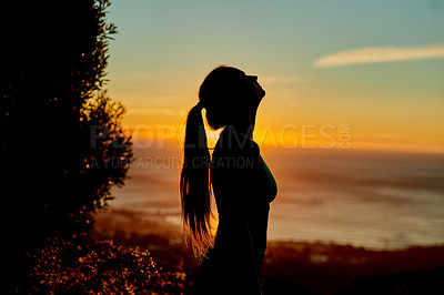 Buy stock photo Cropped shot of a young woman taking a break during her morning run