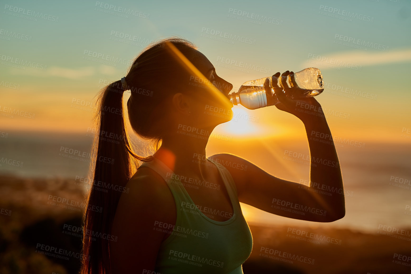 Buy stock photo Drinking water, sunrise and woman silhouette outdoor with break from exercise, fitness and training on the mountain. Nature, wellness and sport workout in the summer with athlete and health by sea