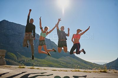 Buy stock photo Shot of a fitness group celebrating after a good workout