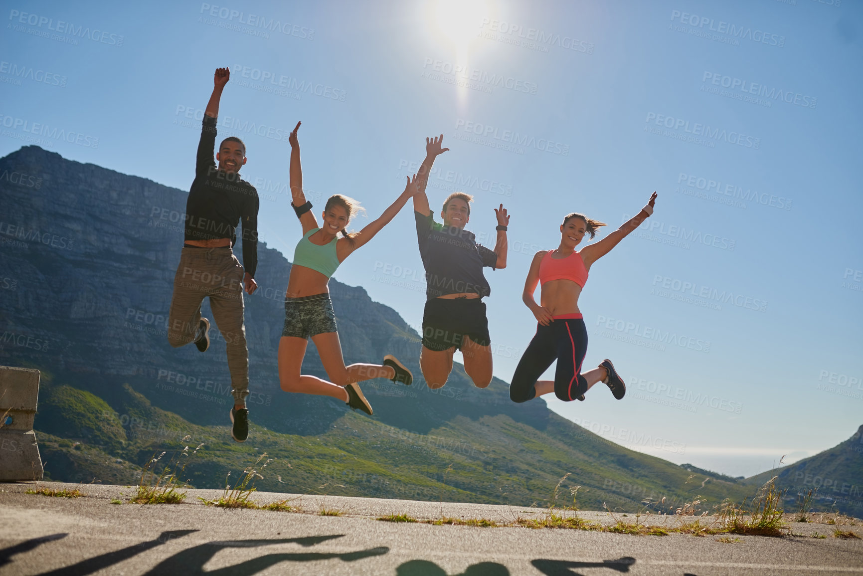 Buy stock photo Outdoor, fitness and jump to celebrate, people and nature of mountain, portrait and happiness for wellness. Athlete, men and women in air, excited and exercise in summer, sports and friends together