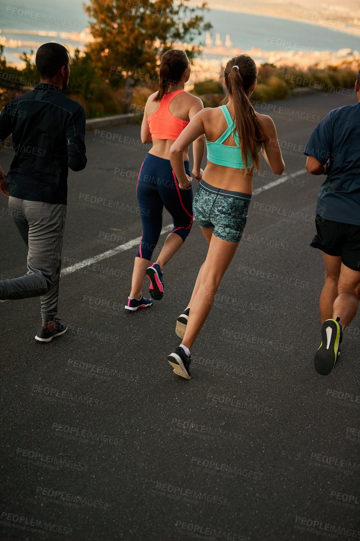 Buy stock photo Running, road or back of people in nature for fitness, race and morning cardio at sunrise. Sports, action or group in street for marathon, training or body performance, speed challenge or competition