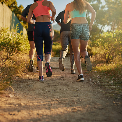 Buy stock photo Cropped shot of a fitness group out running