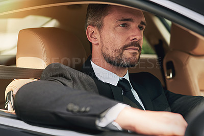 Buy stock photo Cropped shot of a handsome businessman on his morning commute to work