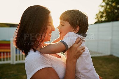 Buy stock photo Shot of a mother and son sharing a tender moment in the backyard