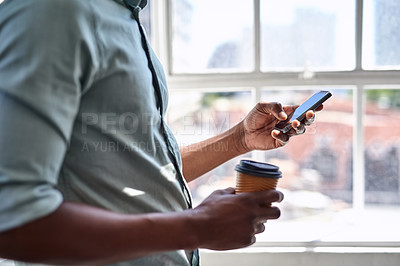 Buy stock photo Cropped shot of an unidentifiable businessman texting on his cellphone in an office