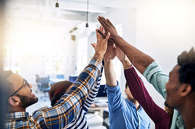 Buy stock photo Cropped shot of a team of designers high fiving together  in an office