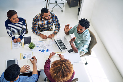 Buy stock photo High angle shot of a team of designers brainstorming together in an office