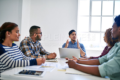 Buy stock photo Cropped shot of a team of designers brainstorming together in an office
