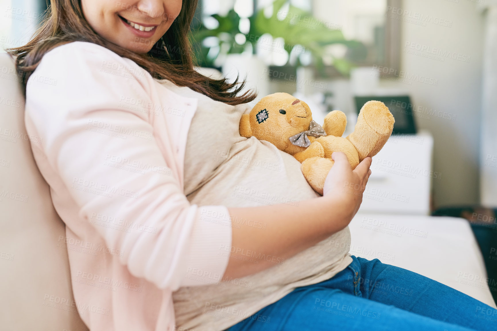 Buy stock photo Home, relax and pregnant woman on sofa with teddy bear, smile and hope for healthy child development. Pregnancy, happy growth and expecting mother on couch with toys, care and wellness in living room