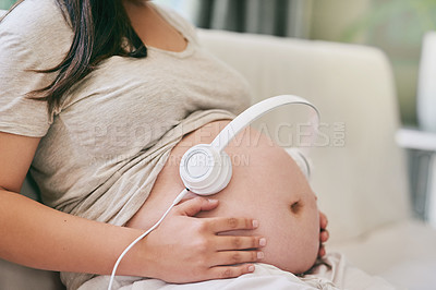 Buy stock photo Relax, sofa and pregnant woman with headphones on stomach for child development in home. Pregnancy, growth and mother on couch with audio, sound therapy and music streaming for bonding with baby