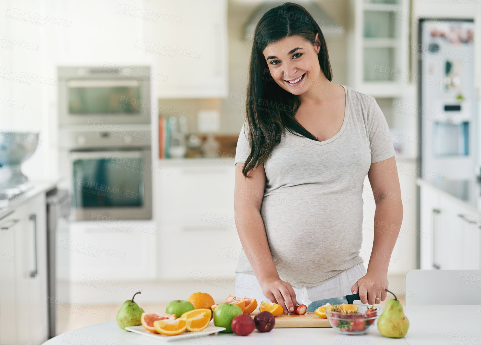 Buy stock photo Woman, pregnant and cutting fruit in portrait, nutrition and vitamin for growth of baby. Female person, organic and vegan snack or home for health, cooking and healthy diet for maternity in kitchen