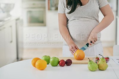 Buy stock photo Woman, pregnant and cutting fruit in home, nutrition and vitamin for growth of baby. Female person, organic and vegan snack or hands for health, cooking and healthy diet for maternity in kitchen