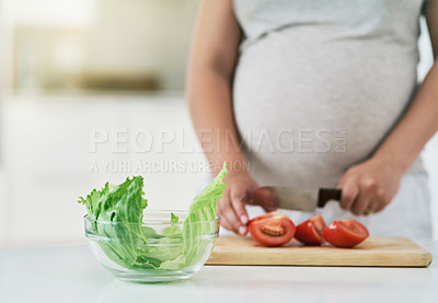 Buy stock photo Woman, pregnant and cutting vegetables in home, nutrition and vitamin for growth of baby. Female person, hands and organic tomatoes or food for health, salad and healthy diet for maternity in kitchen