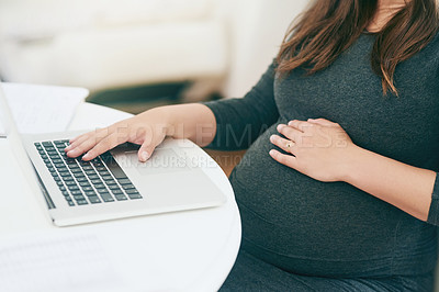 Buy stock photo Shot of an unrecognizable young pregnant woman working from home