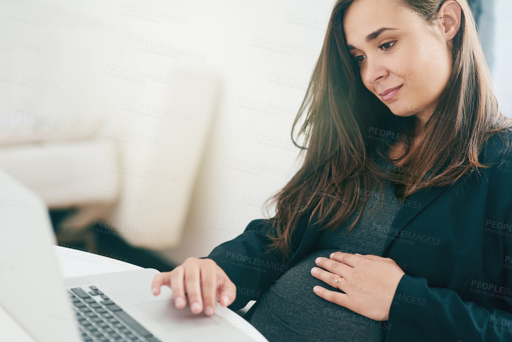 Buy stock photo Cropped shot of an attractive young pregnant woman working from home
