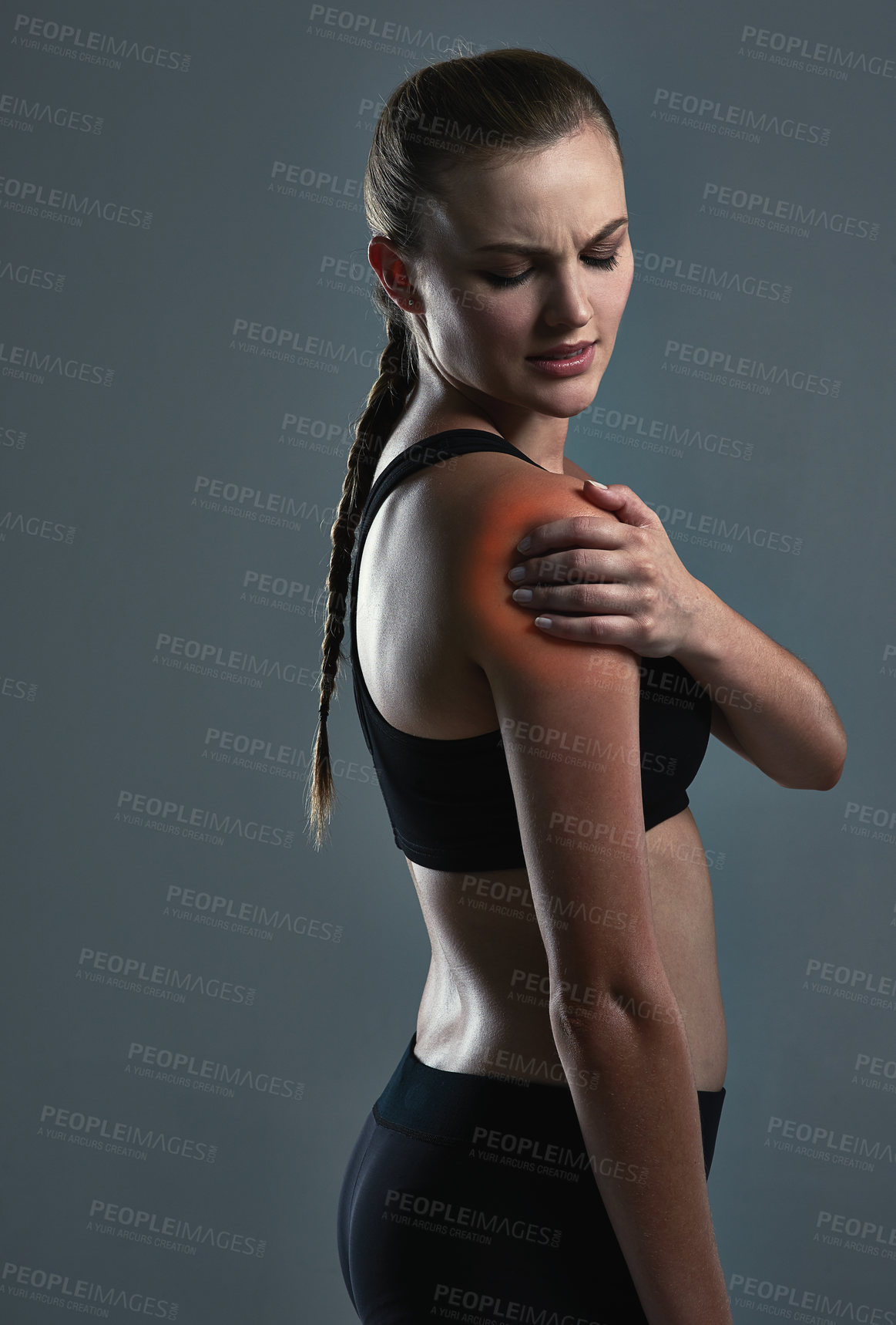 Buy stock photo Fitness, studio and woman with shoulder pain after workout, inflammation and red glow on dark background. Arm injury, female athlete and massage for relief from arthritis, muscle tension or care