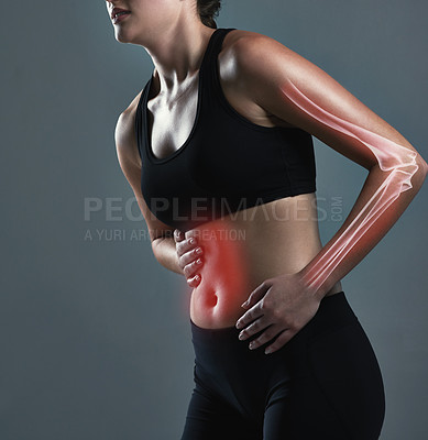 Buy stock photo Studio shot of a sporty young woman experiencing stomachaches