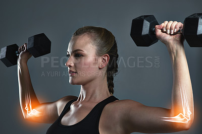 Buy stock photo Studio shot of a sporty young woman building muscle in her arms