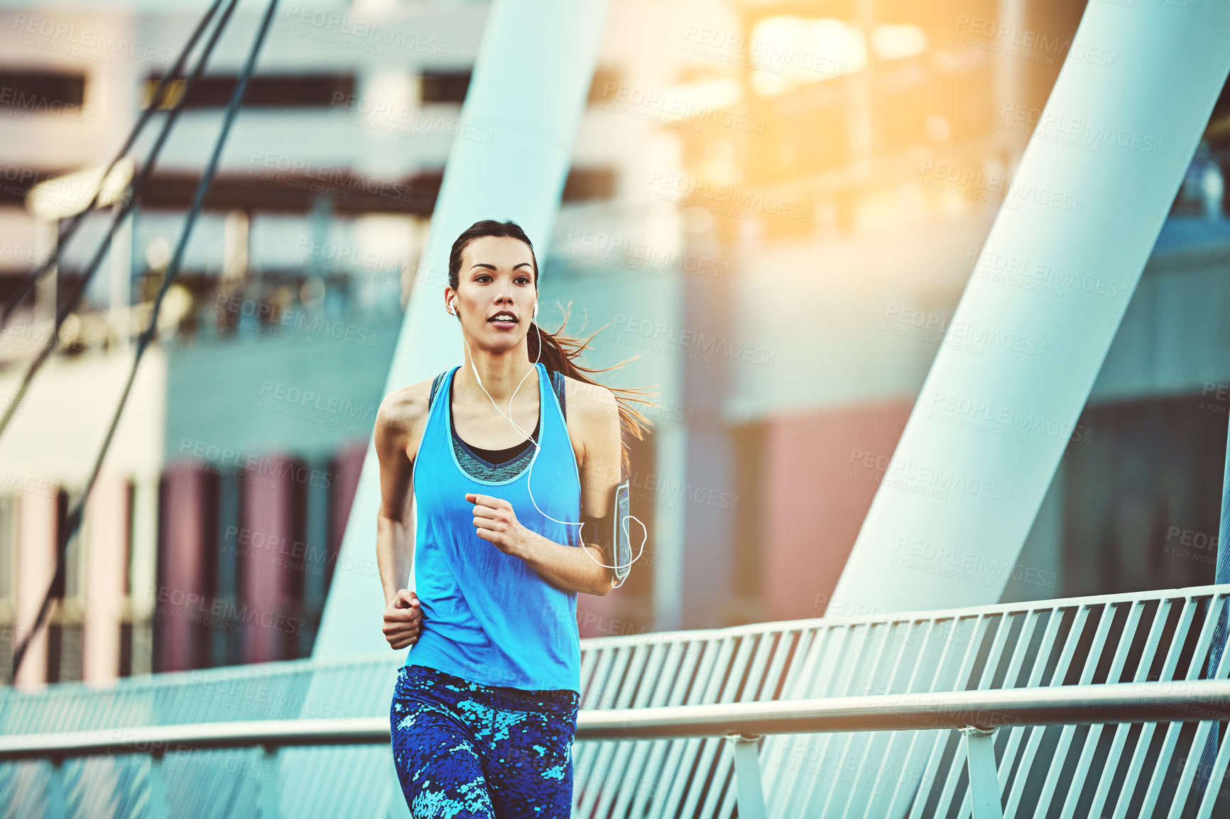 Buy stock photo Shot of a young woman out in the city for her morning run