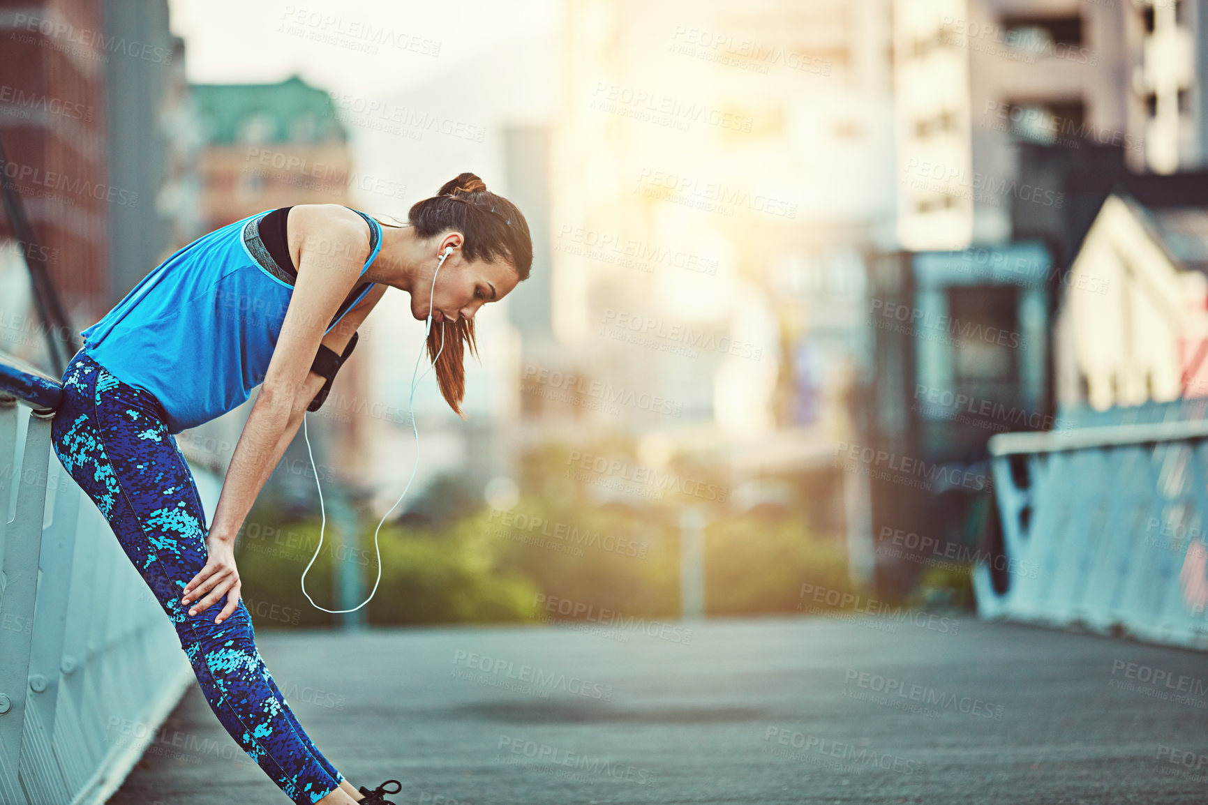 Buy stock photo Shot of a young woman looking exhausted during her morning run