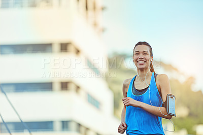 Buy stock photo Shot of a young woman out in the city for her morning run