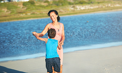Buy stock photo Shot of a mother and son dancing on the beach