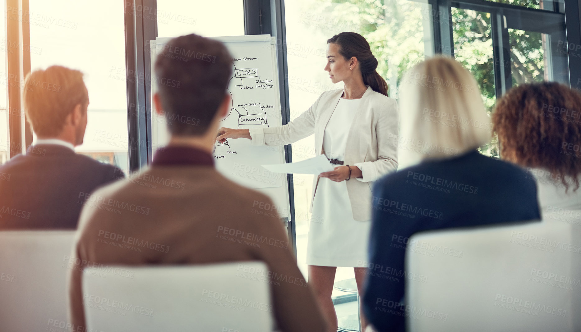 Buy stock photo Cropped shot of a businesswoman giving a presentation to her colleagues in the boardroom