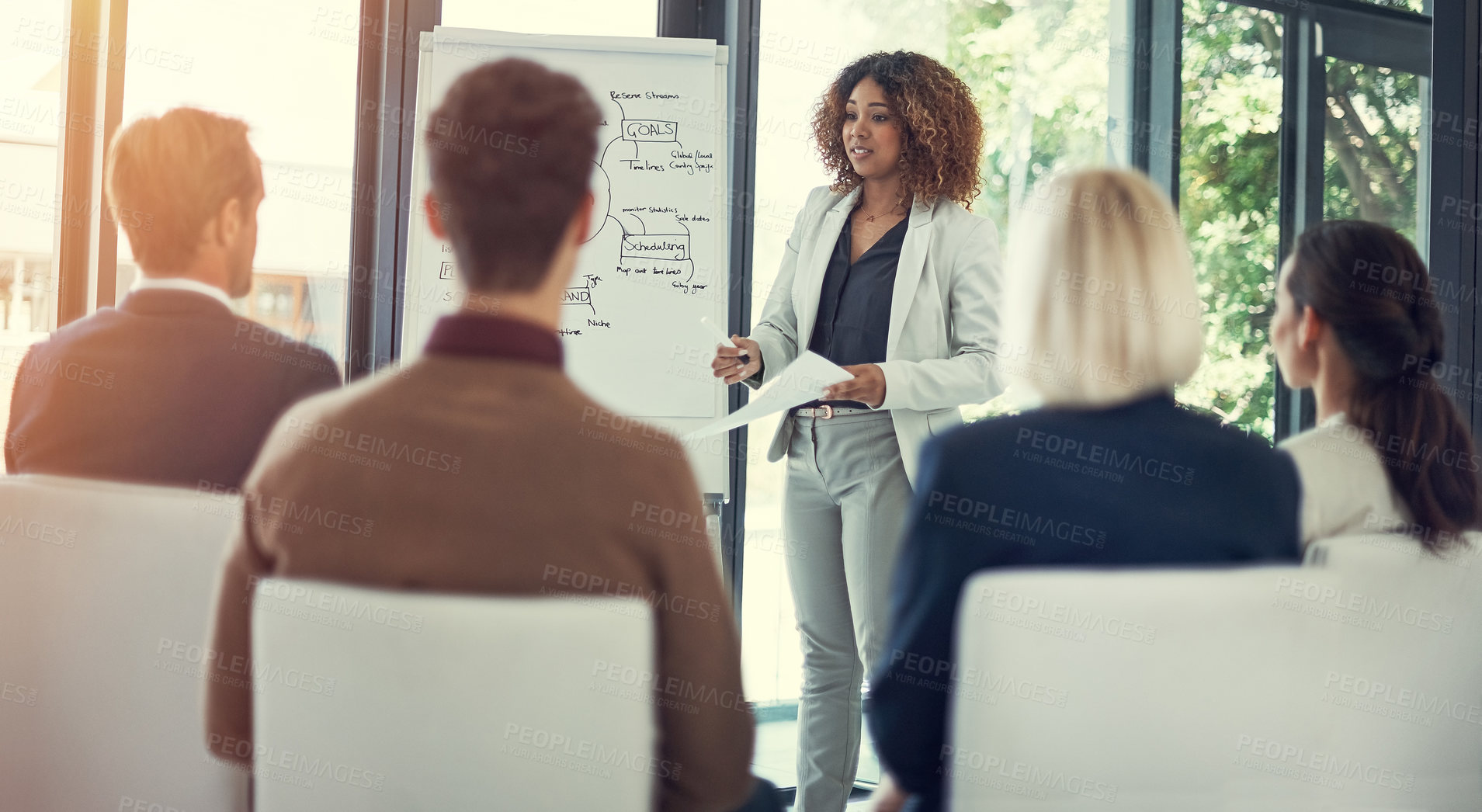 Buy stock photo Cropped shot of a businesswoman giving a presentation to her colleagues in the boardroom