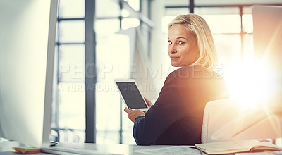 Buy stock photo Shot of a businesswoman using a digital tablet at work