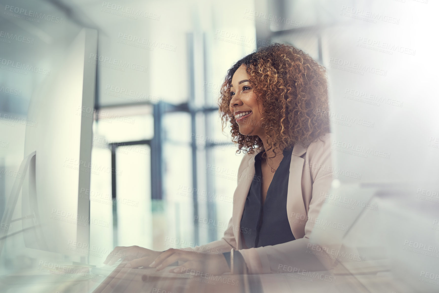 Buy stock photo Shot of a young businesswoman using a computer at her work desk