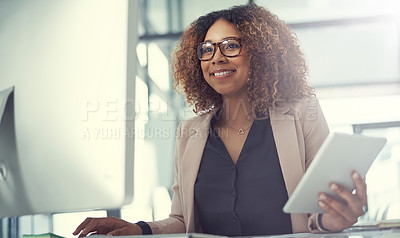 Buy stock photo Shot of a young businesswoman using a digital tablet and computer at work