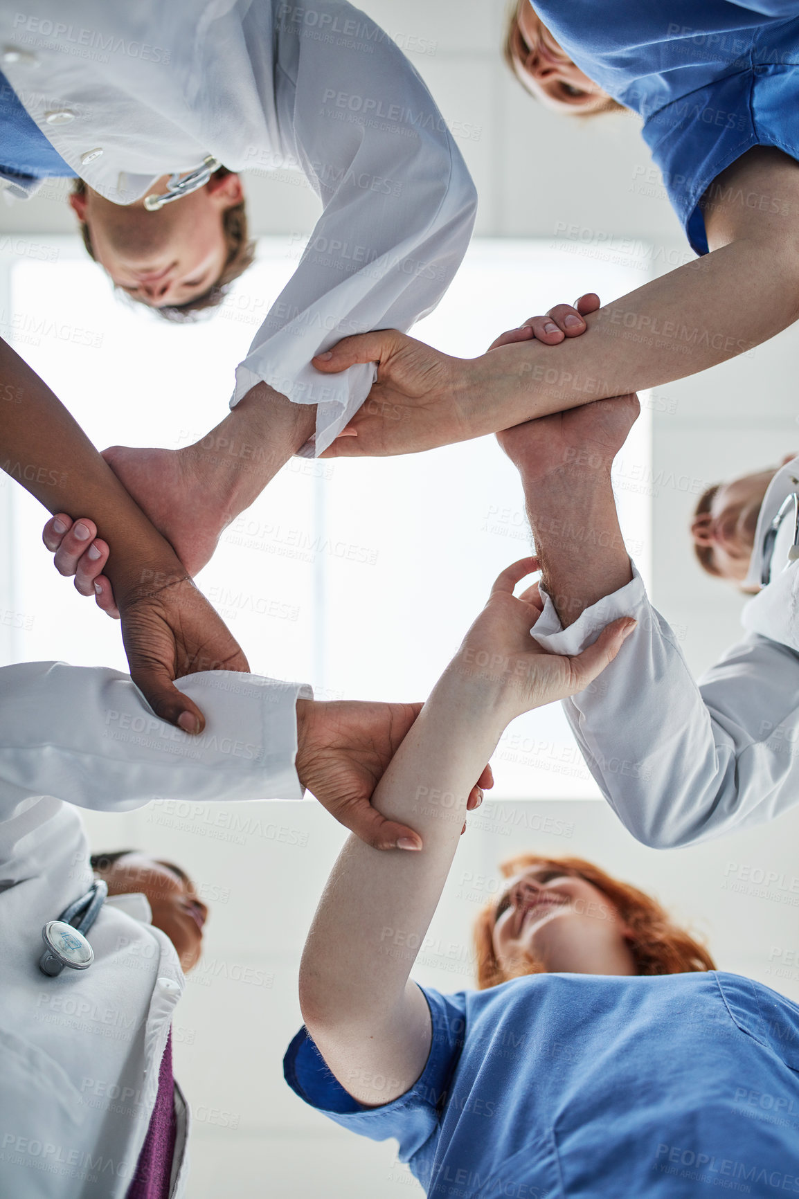 Buy stock photo Doctor, hands together and below with medical team in unity, meeting or motivation at hospital. Low angle or closeup of people or group touching in collaboration, solidarity or mission at clinic