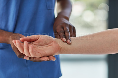 Buy stock photo Closeup shot of a medical practitioner taking a patient's pulse
