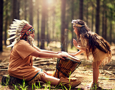 Buy stock photo Native American chief, woman and drum in nature with child for music, connection and learning tribe history. Instruments, mother and daughter with rhythm for culture, teaching and spiritual guide