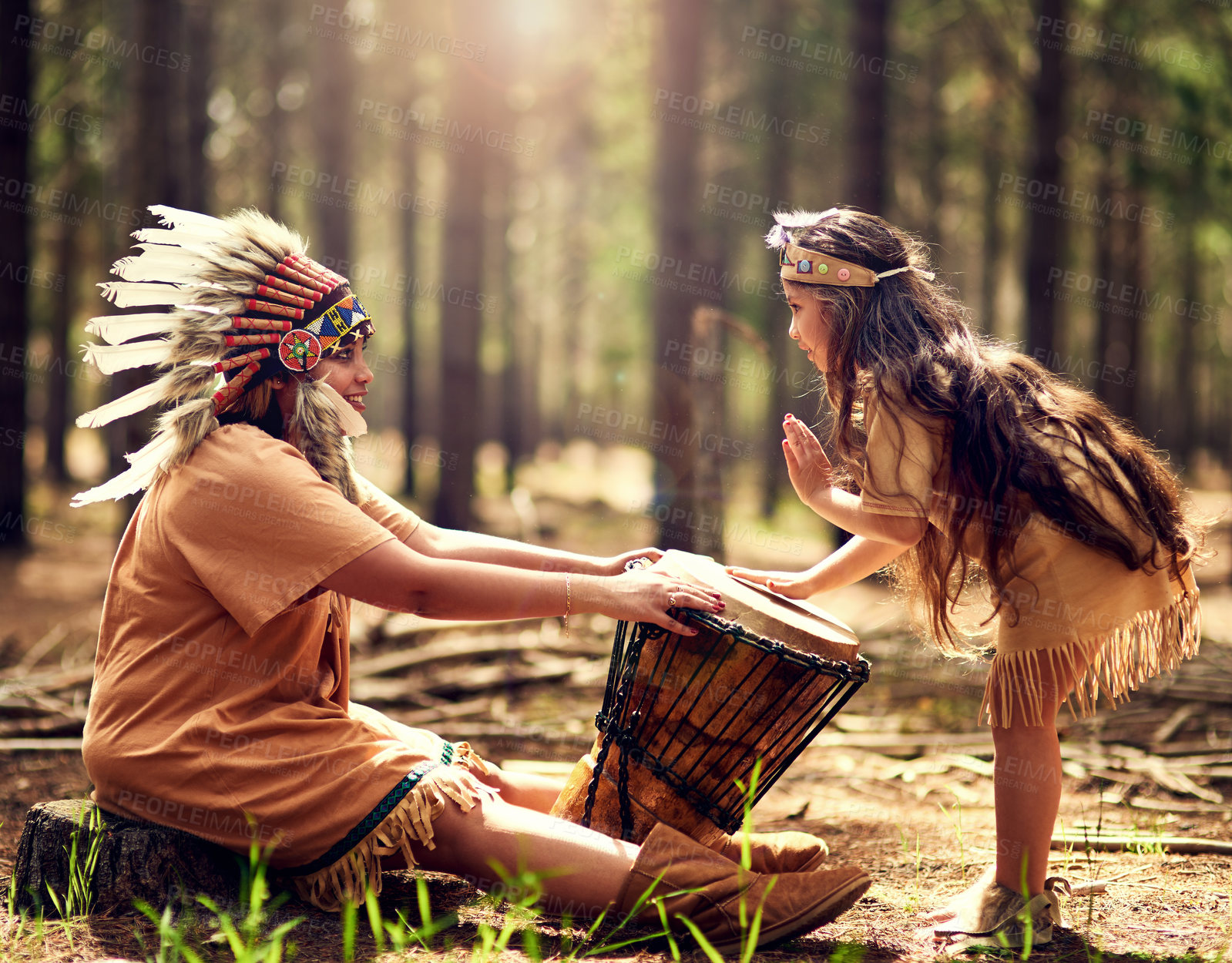 Buy stock photo Native American chief, woman and drum in nature with child for music, connection and learning tribe history. Instruments, mother and daughter with rhythm for culture, teaching and spiritual guide