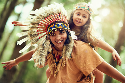 Buy stock photo Portrait of a young woman piggybacking her daughter while playing dressup in the woods