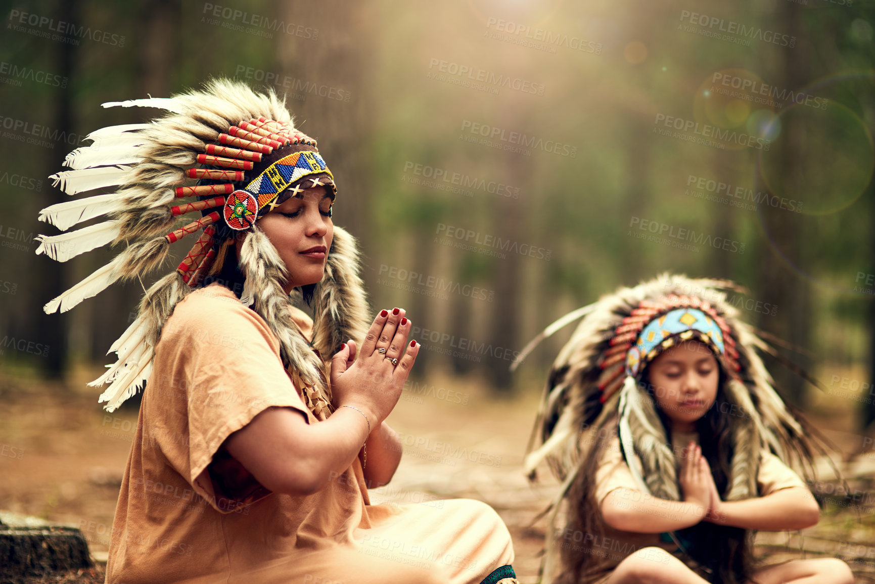 Buy stock photo Native American chief, woman and outdoor for meditation with child for connection to nature in woods. Faith, mother and daughter with mindfulness, peace and breathing with reflection in California