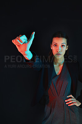 Buy stock photo Portrait of a young businesswoman showing a number with her fingers against a dark background