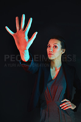 Buy stock photo Portrait of a young businesswoman showing a number with her fingers against a dark background