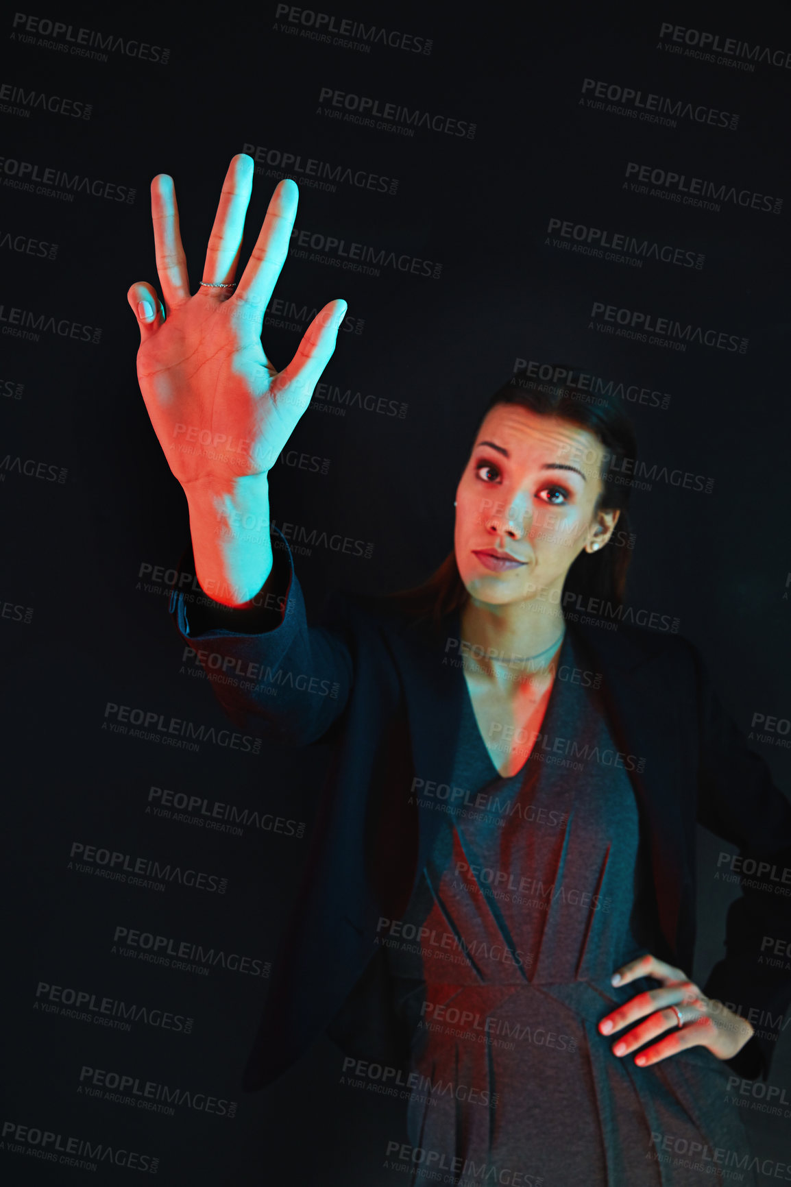 Buy stock photo Portrait of a young businesswoman showing a number with her fingers against a dark background