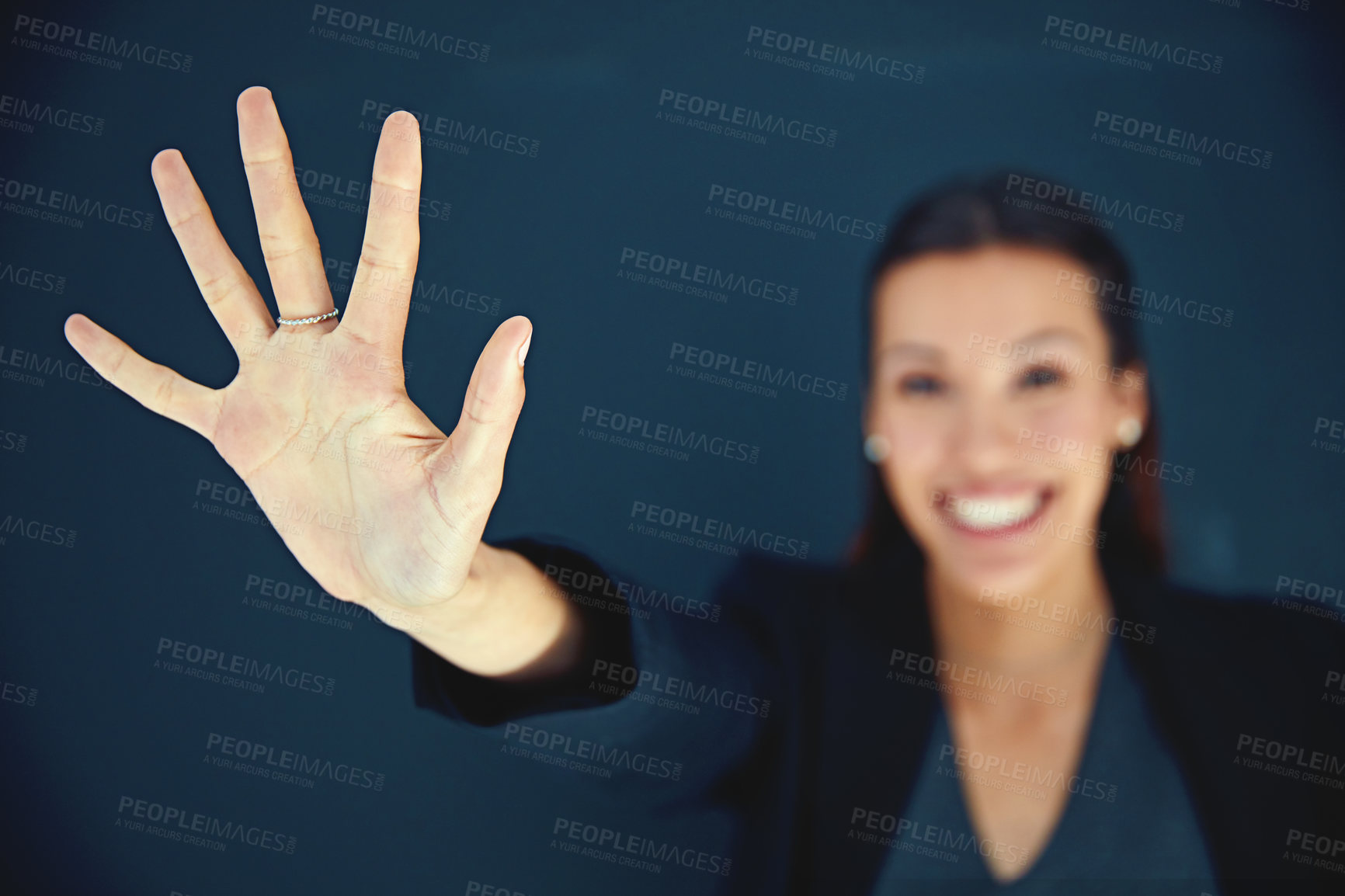 Buy stock photo Portrait of a young businesswoman showing a number with her fingers against a dark background