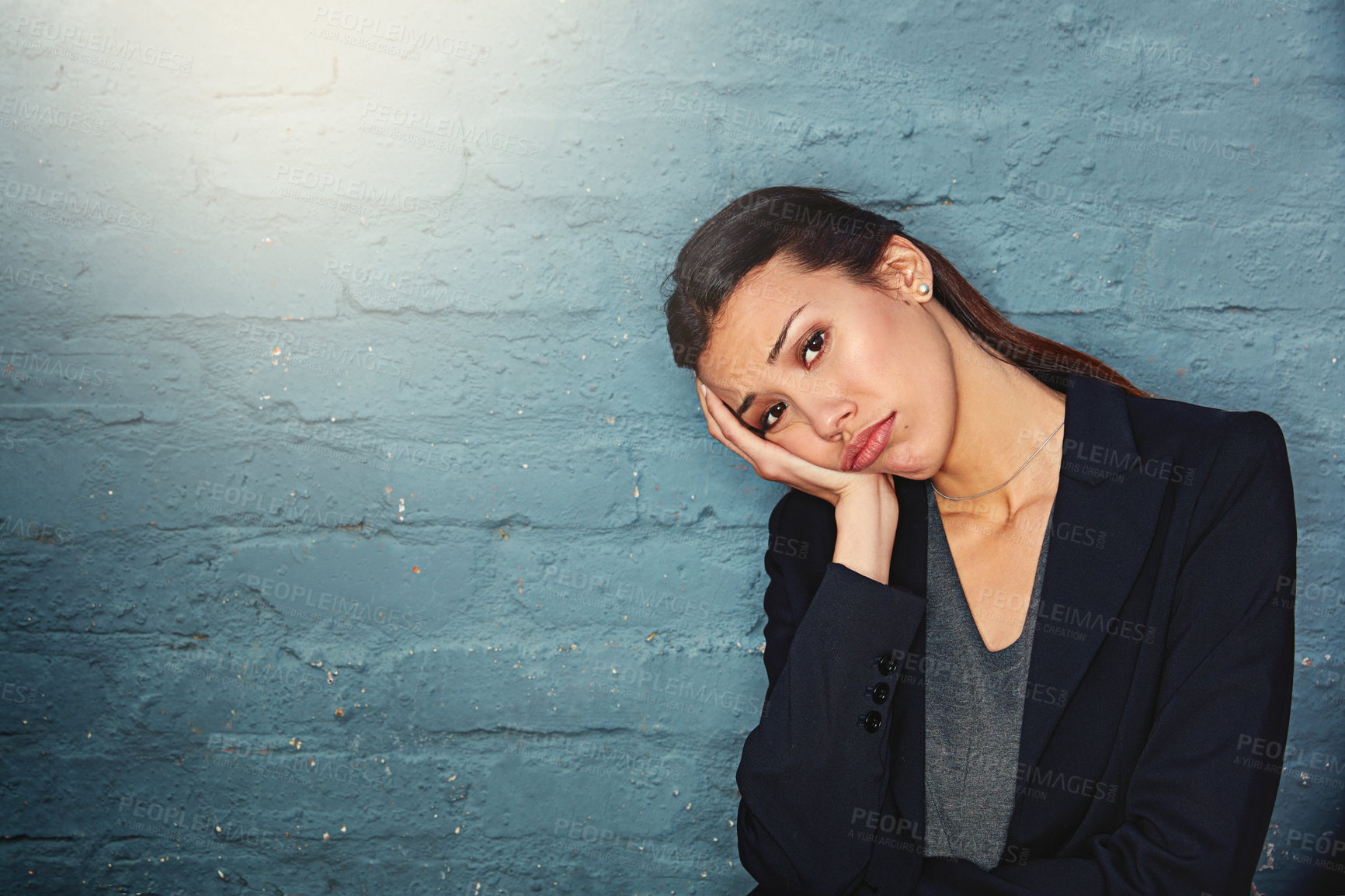 Buy stock photo Portrait of a overworked businesswoman posing against a brick wall