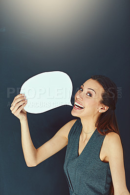 Buy stock photo Portrait of a young woman posing with a speech bubble against a gray background