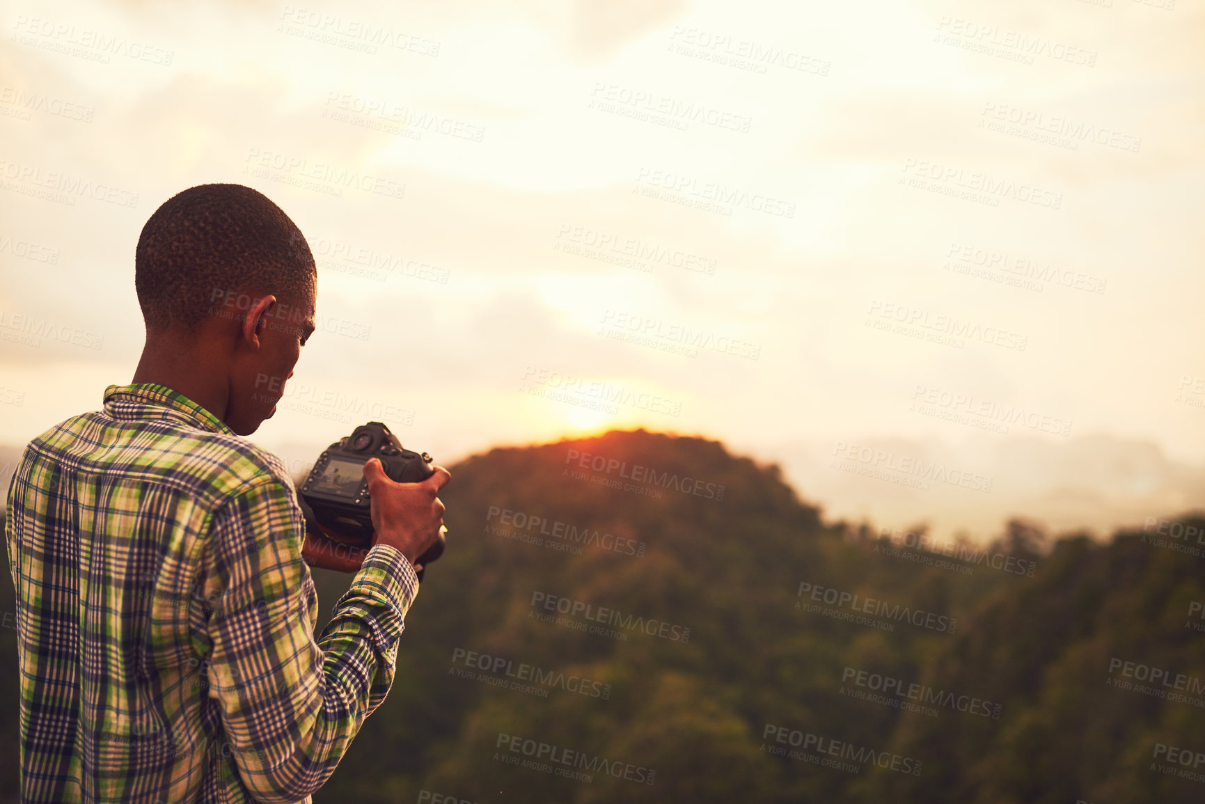Buy stock photo Boy, camera and picture photography on mountain for creative inspiration, travel or sunset. Male person, photo and nature forest for holiday adventure or wilderness environment, safari or journey
