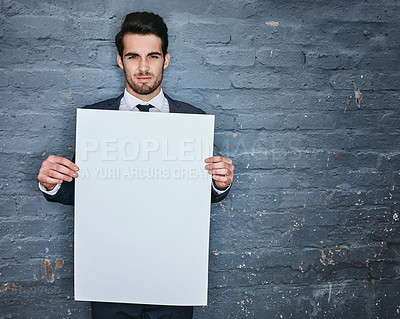 Buy stock photo Shot of a businessman holding up a blank placard