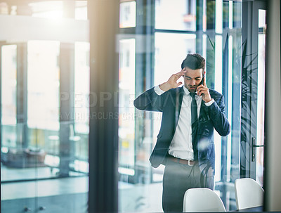 Buy stock photo Shot of a young businessman losing his temper while talking on his cellphone