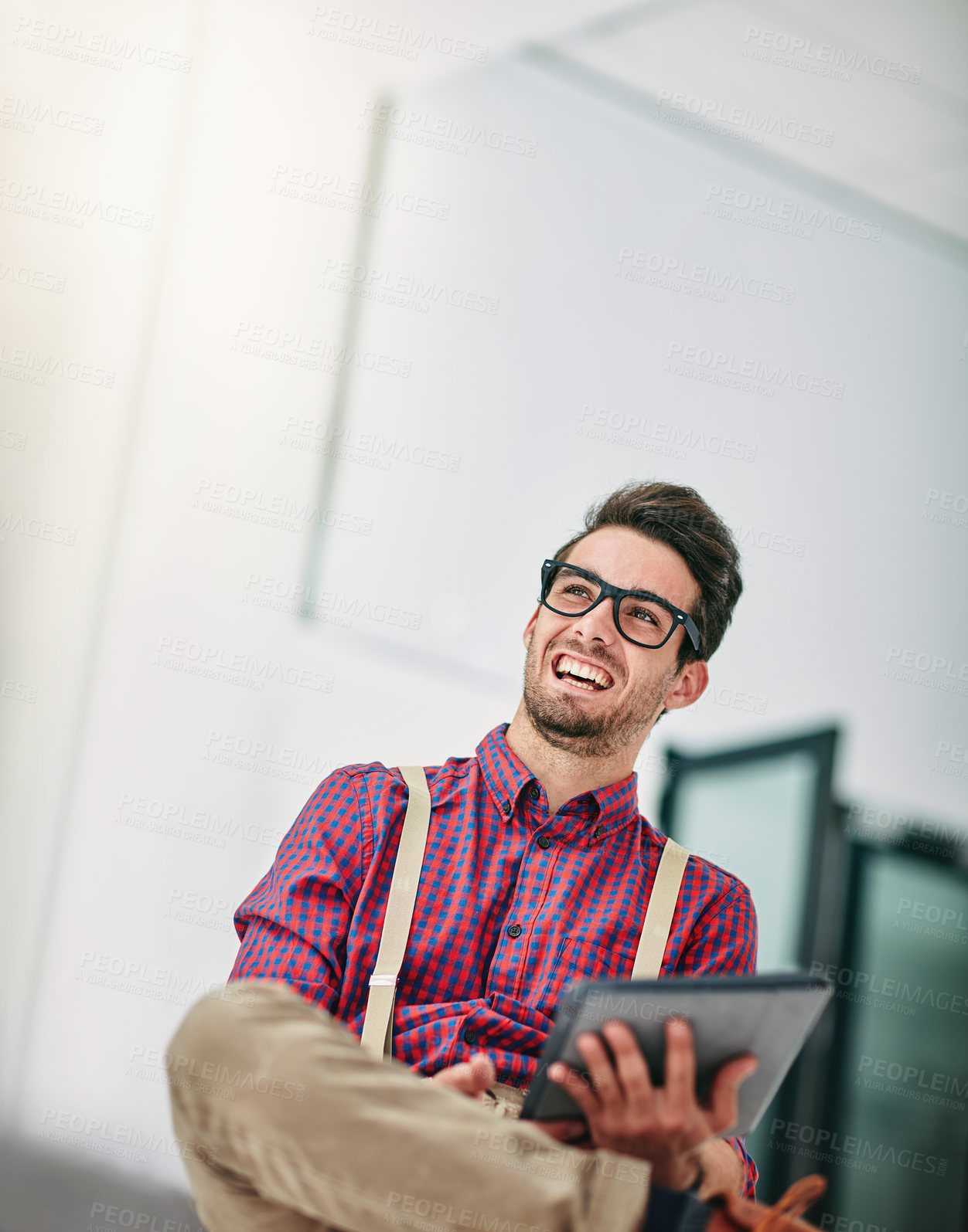Buy stock photo Cropped shot of a handsome young designer using a digital tablet in his office